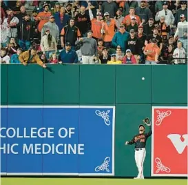  ?? JULIO CORTEZ/AP ?? Orioles outfielder Ryan McKenna makes a catch in front of the new left field wall at Camden Yards. Asked about comments from New York Yankees manager Aaron Boone and outfielder Aaron Judge about the wall, Trey Mancini, the longest-tenured Oriole, acknowledg­ed that it’s not the first time he’s heard such complaints from visiting hitters.