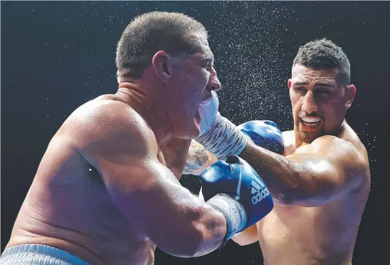  ??  ?? Justis Huni punches Paul Gallen during their Australian heavyweigh­t title fight at ICC Sydney on June 16. Picture: Cameron Spencer/Getty Images