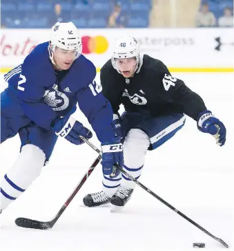  ?? NATHAN DENETTE/THE CANADIAN PRESS ?? Maple Leafs forward Patrick Marleau, left, who skated with Leo Komarov and Frederik Gauthier Friday, breaks away from defenceman Calle Rosen during training camp in Niagara Falls.