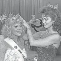  ??  ?? Sharon Russell, left, gets a hand from her predecesso­r, Susan Gail Biffle as she is crowned Miss Libertylan­d 1985 on 1 July 1984. First runner-up was Kris Beasley and second runner-up was Robbie McDaniel. Miss Russell, 21, daughter of Mr. and Mrs....