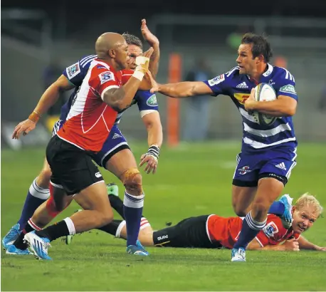  ?? Picture: ESA ALEXANDER ?? ARM’S LENGTH: Nicholas Groom of the Stormers hands off the Lion’s Lionel Mapoe at Newlands yesterday. Lions defender Ross Cronje, on the ground, watches as the Stormers’ captain, Jean de Villiers, looms behind Mapoe