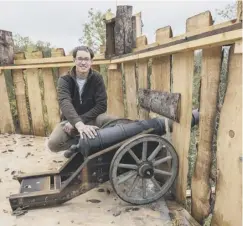  ??  ?? 0 Fergus Hat , 22, who has been busy during lockdown building a castle tree house from timber. The castle turret has a bedroom inside and a ladder which leads up to a rooftop terrace where a replica cannon has been fitted