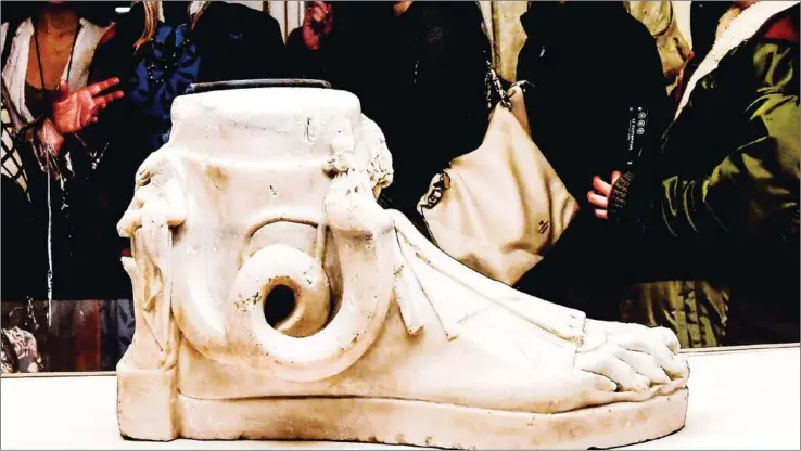  ?? AFP ?? Visitors view a sculpture during the exhibition ‘Worn by the Gods’ at the Fashion and Costume Museum in Palazzo Pitti in Florence on Thursday.