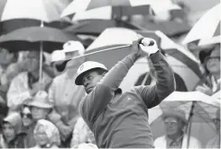  ?? The Associated Press ?? ■ Lee Elder watches the flight of his ball as he tees off in the first round of play at the Masters in Augusta, Ga., on April 10, 1975. Elder broke down racial barriers as the first Black golfer to play in the Masters and paved the way for Tiger Woods and others to follow. The PGA Tour confirmed Elder’s death, which was first reported by Debert Cook of African American Golfers Digest.