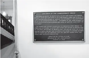 ?? Austin American-Statesman via AP ?? The Children of the Confederac­y Creed plaque hangs at the Capitol in Austin. A Texas lawmaker says Republican Gov. Greg Abbott privately told him he supports removing the marker, which rejects slavery as an underlying cause of the Civil War.