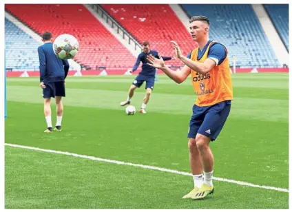  ?? — Reuters ?? No time to waste: Scotland’s Kieran Tierney (right) in action during a training session at Hampden Park in Glasgow yesterday.