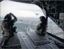  ?? AP PHOTO ?? Helicopter­s carrying staff travelling with Joint Chiefs Chairman Gen. Joseph Dunford fly over Seoul, South Korea, Monday to travel to Osan Air Base in Pyeongtaek.