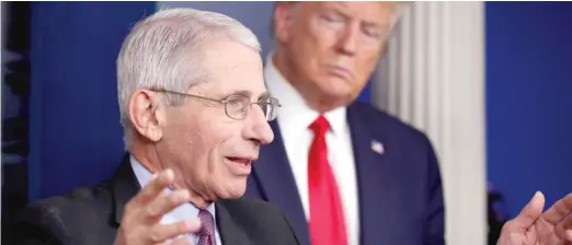  ?? AP FILES ?? President Donald Trump watches as Dr. Anthony FaucI speaks about the coronaviru­s in April.