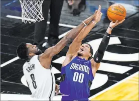  ?? John Raoux The Associated Press ?? Nets forward Jeff Green fouls Magic forward Aaron Gordon in the first half of Orlando’s 121-113 win Friday at Amway Center. Gordon scored 38 points.