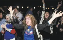  ?? Zach Gibson / Getty Images ?? JoAnn Loulan (center) and mother-in-law Sydney Crawford (left) are jubilant after Democrats win control of the House.