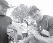  ?? PHELAN M. EBENHACK/AP ?? Atlanta Braves infielder Chase D'Arnaud shares a laugh with fans. He is an accomplish­ed musician about to release material for his second album.