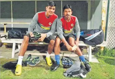  ?? HT PHOTO ?? East Bengal goalkeeper­s Gurpreet Singh (left) and Abhijit Mondal take a break from training at the Al Kuwait Sports Stadium in Kuwait City on Monday.