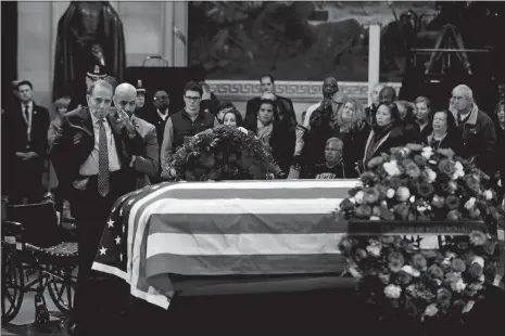  ?? MANUEL BALCE CENETA/AP PHOTO ?? Former Sen. Bob Dole, R-Kan., salutes the flag-draped casket containing the remains of former President George H.W. Bush as he lies in state at the U.S. Capitol in Washington on Tuesday.