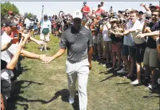  ?? Michael Dwyer / Associated Press ?? Fans cheer as Tiger Woods walks off the third green during the third round of the Dell Technologi­es Championsh­ip on Sunday.