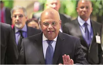  ?? AP ?? Back in the hot seat Pravin Gordhan has been reappointe­d finance minister by South African president Jacob Zuma, as the government seeks to contain fallout after the dismissal of Nhlanhla Nene.