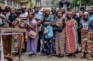  ?? - AFP file photo ?? PRELIMINAR­Y RESULTS: Voters queue in order to cast their ballot for the DR Congo’s general elections at the College St Raphael polling station in Kinshasa. The electoral commission had promised to announce preliminar­y results on Sunday, followed by a definitive count on January 15.