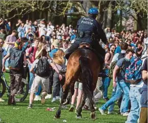 ?? EPA PIC ?? Police on horseback trying to disperse people who took part in a fake concert announced on social media as an April Fool’s Day joke in Brussels, Belgium, on Thursday.