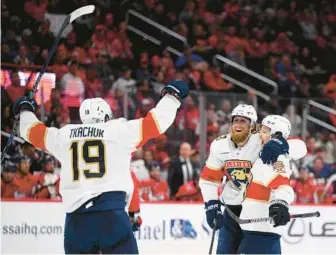  ?? NICK WASS/AP ?? Panthers defenseman Marc Staal, center, celebrates his goal against the Capitals with defenseman Brandon Montour, right, and left wing Matthew Tkachuk during the second period Thursday in Washington, D.C.