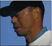  ?? JOHN MINCHILLO — THE ASSOCIATED PRESS ?? Tiger Woods walks off the fourth tee during the second round of the US Open on Friday.