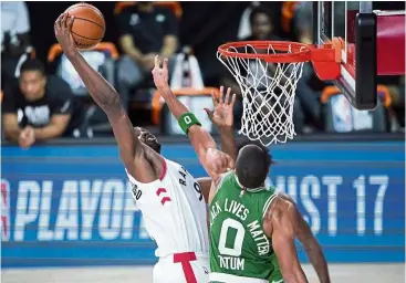  ?? — AFP ?? It’s mine: Toronto Raptors’ Serge Ibaka (left) reaches for a rebound against Boston Celtics’ Jayson Tatum (0) during the second half of their NBA game on Friday.