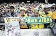  ??  ?? Some of the 20 000 people, with one of them holding a poster with legendary ANC leader and former South African president Nelson Mandela, celebrate during the 105th anniversar­y rally of the ruling ANC in Soweto in January 2017.