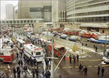  ?? BETSY HERZOG — THE ASSOCIATED PRESS FILE ?? In this file photo, emergency vehicles and personnel fill New York’s West Street following an undergroun­d explosion that rocked the World Trade Center. It was a terror attack that foreshadow­ed Sept. 11: the deadly World Trade Center bombing that happened 25years ago Monday.