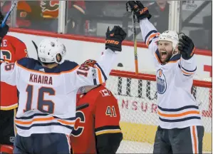  ?? CP PHOTO MIKE DREW ?? Calgary Flames goalie Mike Smith looks up as Edmonton Oilers’ Jujhar Khaira, left, celebrates his goal with Zack Kassian during first period NHL hockey action in Calgary, Saturday.