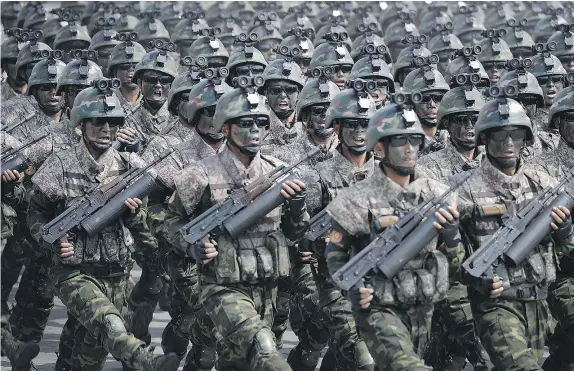  ??  ?? Commandos march in a show of military might in Pyongyang, North Korea earlier this month. That country’s leadership is determined to develop a nuclear missile that can strike the United States, says Adm. Harry Harris Jr., commander of U.S. Pacific...