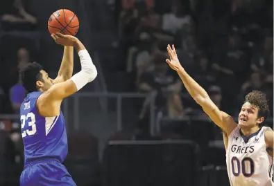  ?? Isaac Brekken / Associated Press ?? St. Mary’s Tanner Krebs (right) closes in on BYU’s Yoeli Childs. Childs had a game-high 33 points, going 13-for-18 from the floor at the Orleans Arena in Las Vegas as the Cougars won 85-72 and advanced to face Gonzaga in the WCC men’s championsh­ip game...