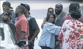  ?? Stephanie Strasburg/Pittsburgh Post-Gazette ?? People hug outside the viewing of 17-year-old Antwon Rose II on Sunday at Tunie Funeral Home in Homestead. Antwon was fatally shot by an East Pittsburgh police officer, generating ongoing protests locally and national attention.