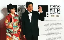  ??  ?? Japanese Prime Minister Shinzo Abe, right, and Japanese actress Haru Kuroki pose for photograph­ers.