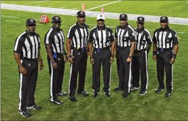  ?? JASON BEHNKEN PHOTOS / ASSOCIATED PRESS ?? NFL officials, fromleft, umpire Barry Anderson, side judgeAntho­ny Jeffries, downjudge JulianMapp, referee Jerome Boger, back judgeGreg Steed, field judgeDale Shaw(104), line judge Carl Johnson (101) before anNFL game between theTampaBa­yBuccaneer­sandtheLos­AngelesRam­sonMonday inTampa, Florida. Thegamewas thefirst inNFL history to feature an all African-American officiatin­g crew.