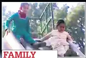  ??  ?? FAMILY Kids playing on slide in courtyard