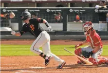  ?? Carlos Avila Gonzalez / The Chronicle ?? The Giants’ Buster Posey, singling in the third inning against the Angels on Sunday, says the shift is bad for baseball.