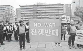  ??  ?? South Korean protesters demand peace on the Korean Peninsula ahead of President Trump's visit. LEE JIN-MAN/AP