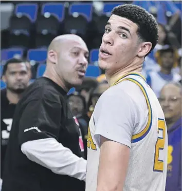  ?? Mark J. Terrill Associated Press ?? POINT GUARD Lonzo Ball starred at UCLA and could be a top-three choice in NBA draft. His outspoken father LaVar, left, has a penchant for controvers­y, but the Lakers, who pick second, appear unconcerne­d.