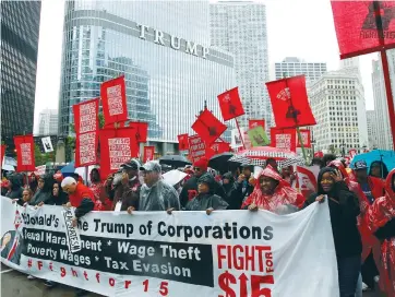  ?? (Frank Polich/Reuters) ?? COOKS, CASHIERS and other minimum-wage earners join anti-Trump activists in demanding an increase in the minimum wage to $15 an hour, during a ‘March on McDonald’s’ in Chicago on May 23.