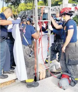  ?? DELRAY BEACH FIRE RESCUE/COURTESY ?? Fire rescue officials rescue a woman who was trapped inside an 8-foot deep storm drain in Delray Beach on Tuesday morning.