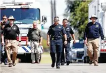  ??  ?? Lake Worth Police Chief J.T. Manoushagi­an, center, and other officials investigat­e near the location where the jet crashed Sunday.
