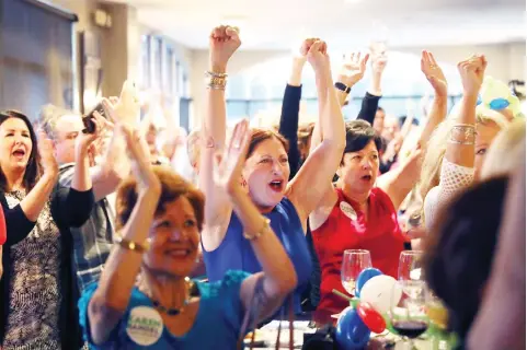  ??  ?? People react as Republican candidate Karen Handel speaks during a campaign in Houck’s Grille, Georgia, on Monday. (AFP)