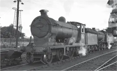  ?? D Dunn Collection ?? Reid ‘D34’ or ‘Glen’ class 4-4-0 No 62484 Glen Lyon – new from Cowlairs Works in April 1919 as NBR ‘149’ class No 278 – is seen at Canal shed on Saturday, 29 July 1961, in company with a ‘J39’ as they reside over the ash pit installed in the 1935/36 improvemen­ts. The 4-4-0 has worked down from its base at Hawick (note that no shed plate is carried), where it had been resident since November 1960; it would be withdrawn on the following 6 November to enter a long period in store before being moved to the scrap yard of Arnott, Young of Old Kilpatrick in May 1963. The ‘D34s’ had no post-grouping allocation to Canal shed but appearance­s were common, albeit just six of the class were in regular traffic by the start of 1961. Just ahead of the ‘D34’ to the left are narrow gauge skips used by the ash plant, a nearby lighting post and its ladder appears to have offered a convenient place for a fireman to prop up his tools, and the shed’s 65ft turntable is beyond.