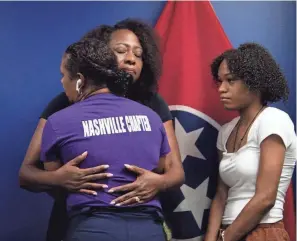  ?? NICOLE HESTER / THE TENNESSEAN ?? Rafiah Muhammad-mccormick, with Moms Over Murder, is hugged by Karen Johnson during a news conference where Muhammad-mccormick spoke about the killing of her son, Rodney Armstrong, at Cordell Hull State Office Building in Nashville on July 20.