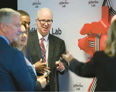  ?? STEPHEN M. KATZ/STAFF ?? Stuart Henderson, director of Jefferson Lab, and other officials attend Tuesday morning’s celebratio­n at the lab’s Applied Research Center.