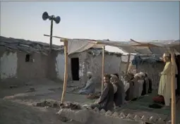  ?? Felipe Dana/Associated Press ?? Afghans pray in a mosque at a poor neighborho­od where hundreds of internally displaced people from the eastern part of the country have been living in Kabul.