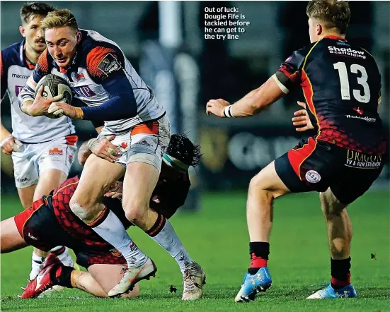  ??  ?? Out of luck: Dougie Fife is tackled before he can get to the try line