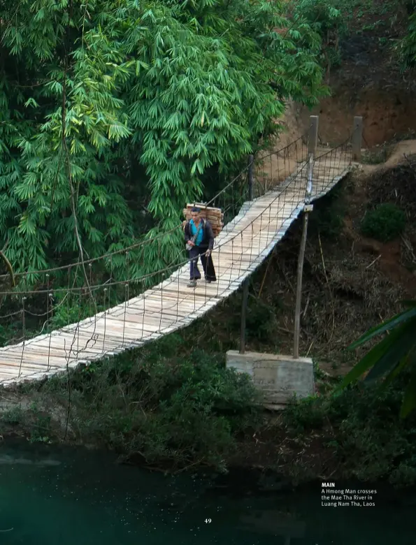  ??  ?? A Hmong Man crosses the Mae Tha River in Luang Nam Tha, Laos