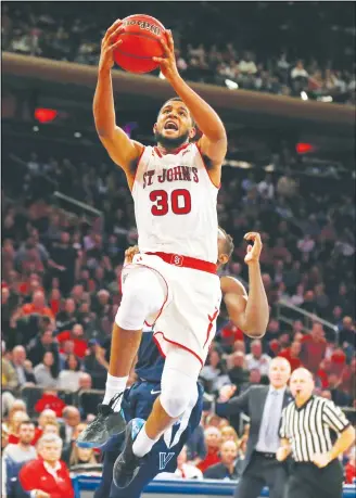  ??  ?? St. John’s guard L.J. Figueroa drives to the basket against Villanova during the second half of an NCAAcolleg­e basketball game on Feb 17 in New York. (AP)