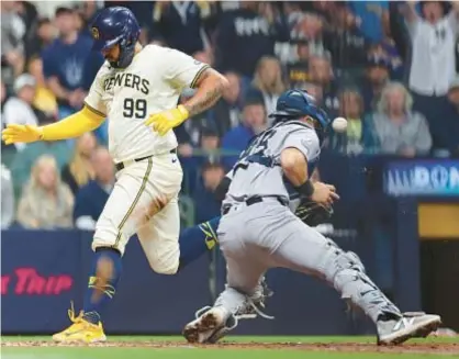  ?? GETTY ?? Gary Sánchez beats tag at home by Austin Wells in sixth inning of Brewers’ 11-inning victory Friday night in Milwaukee.