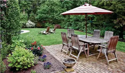  ?? Dreamstime / TNS ?? In general, it costs less to build a patio than a deck, according to Bob Vila.
