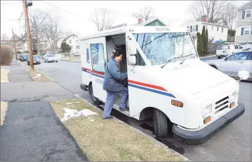  ?? Hearst Connecticu­t Media file photo ?? A U.S. postal worker enters her truck while delivering mail on Henry Street in the Byram section of Greenwich in 2013.